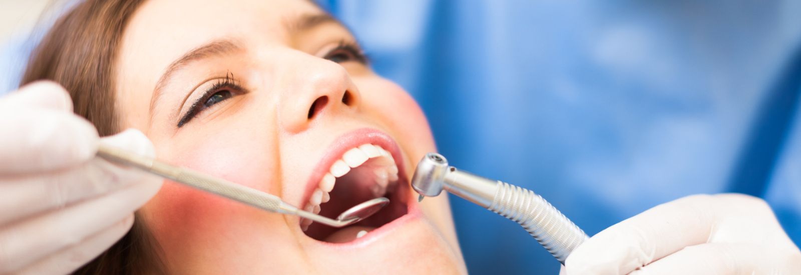Dentist examining patients mouth